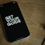 A cell phone sitting on top of a wooden table